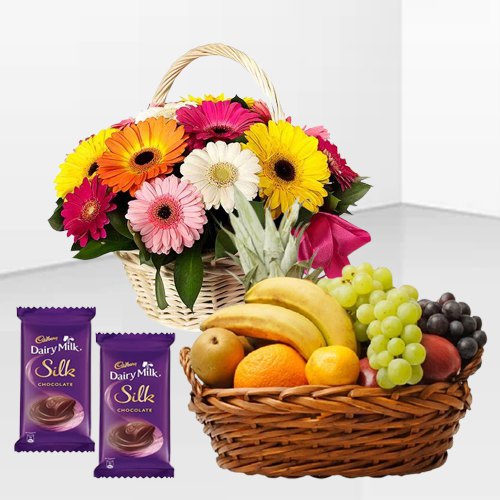 Delectable Dairy Milk Silk with Mixed Fruits Basket and Gerberas Arrangement