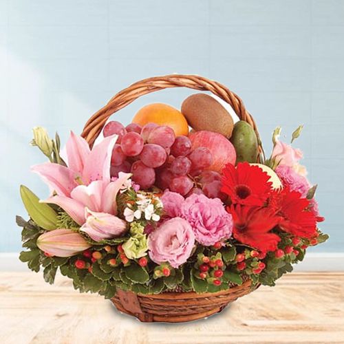 Provocative Basket of Fresh Fruits decorated with Lily, Roses n Gerberas